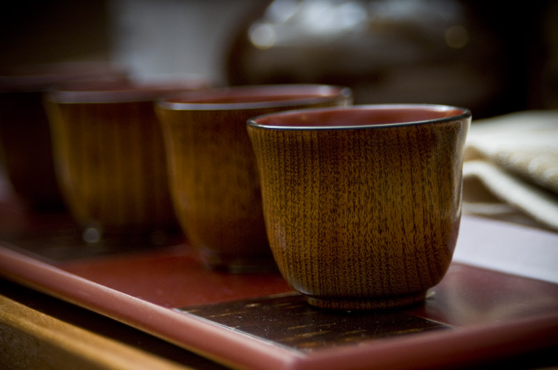 Detail of wooden cups on tray.