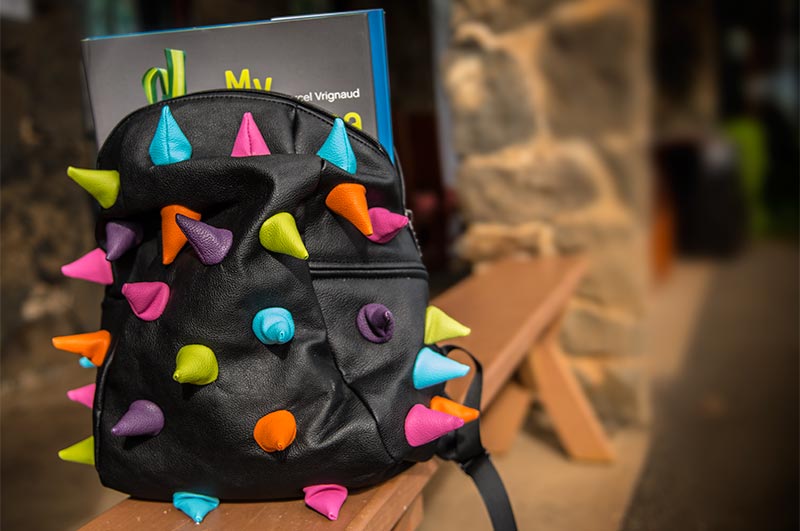 Bright colored spikes on a black backpack by Mad Pax.