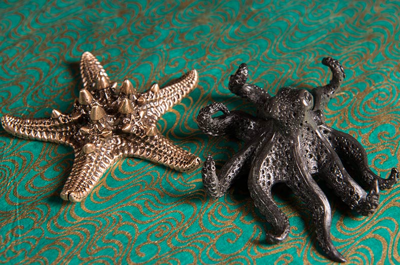 Pewter cast objects of an octopus and starfish