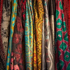 Lots of colorfu, patterned scarves on display.