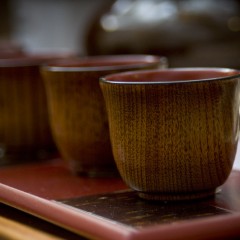 Detail of wooden cups on tray.