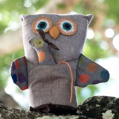Maileg Owl stuffed toy sitting on a tree limb.