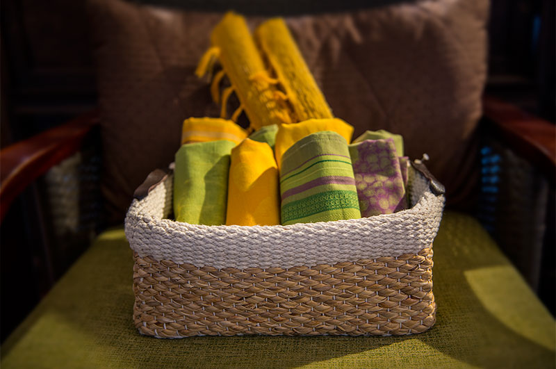Picture of woven basket filled with rolled linens.