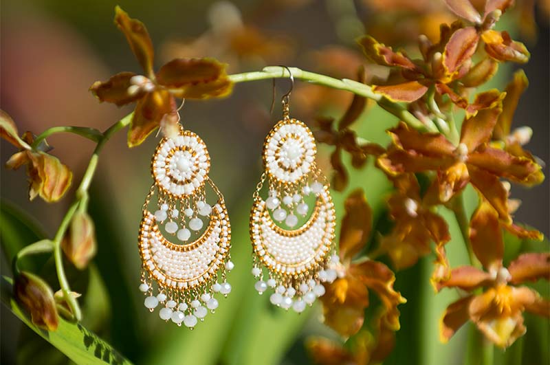 White chandelier earrings by artist Miguel Ases