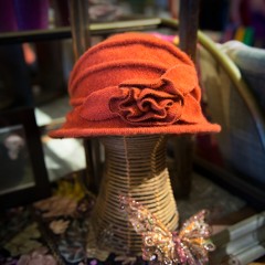 Beautiful orange, vintage-styled woman's hat on display at Kong Lung Trading