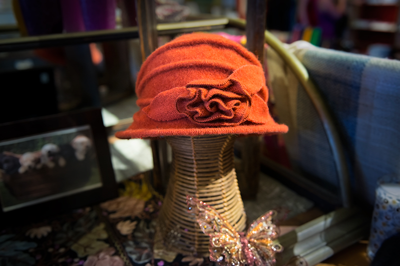 Beautiful orange, vintage-styled woman's hat on display at Kong Lung Trading