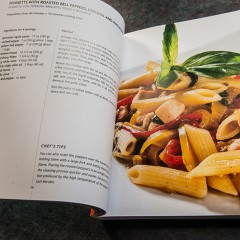 cookbook open to photo of beautiful pasta dish