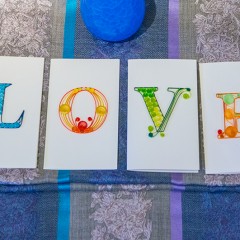 four greeting cards spell out LOVE